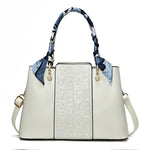 Chic Embossed Leather Handbag with Decorative Scarf Handle