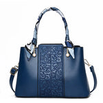 Chic Embossed Leather Handbag with Decorative Scarf Handle